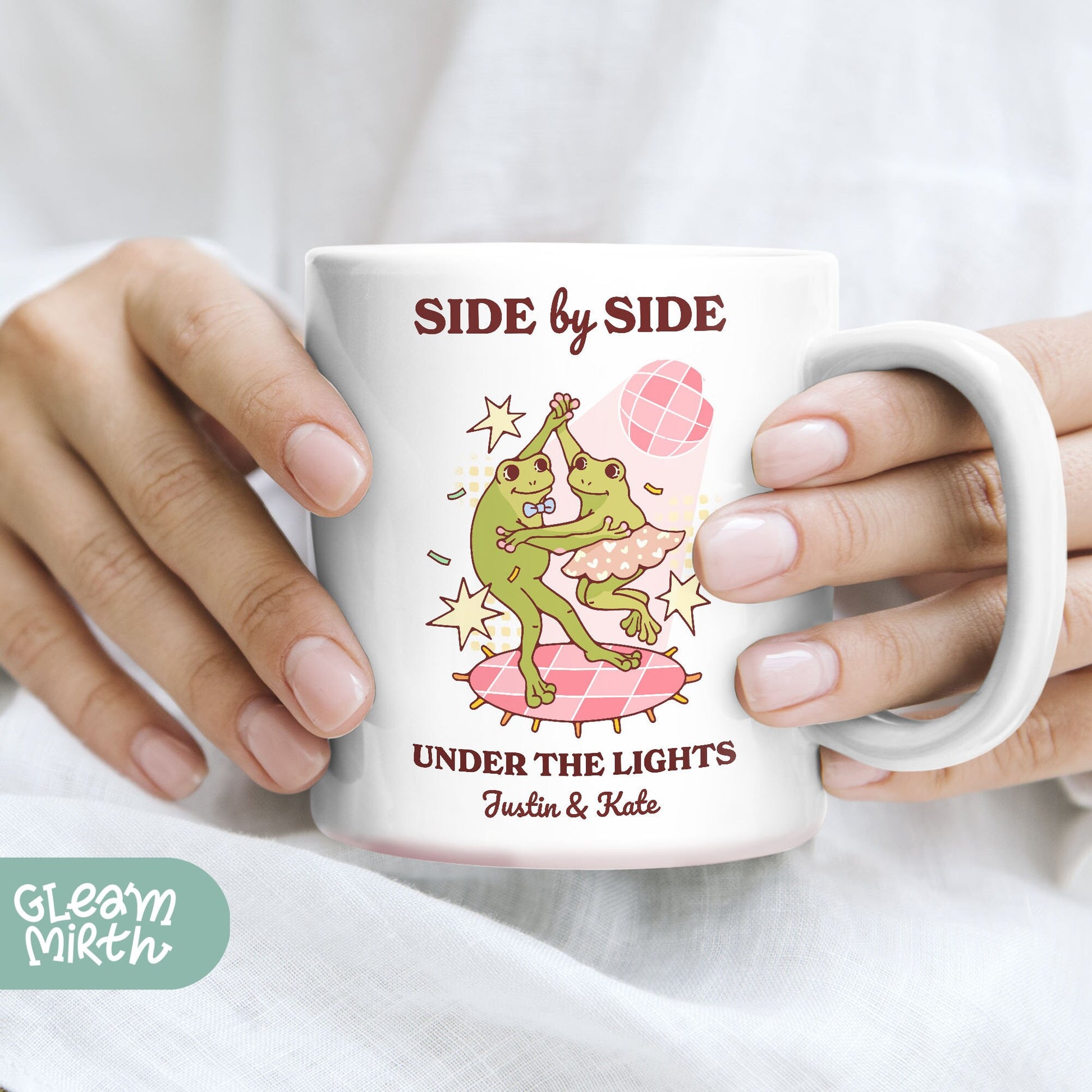 a woman holding a coffee mug with a picture of a frog on it