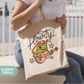 a woman sitting on a bench holding a tote bag