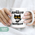 a person holding a white coffee mug with a black cat on it