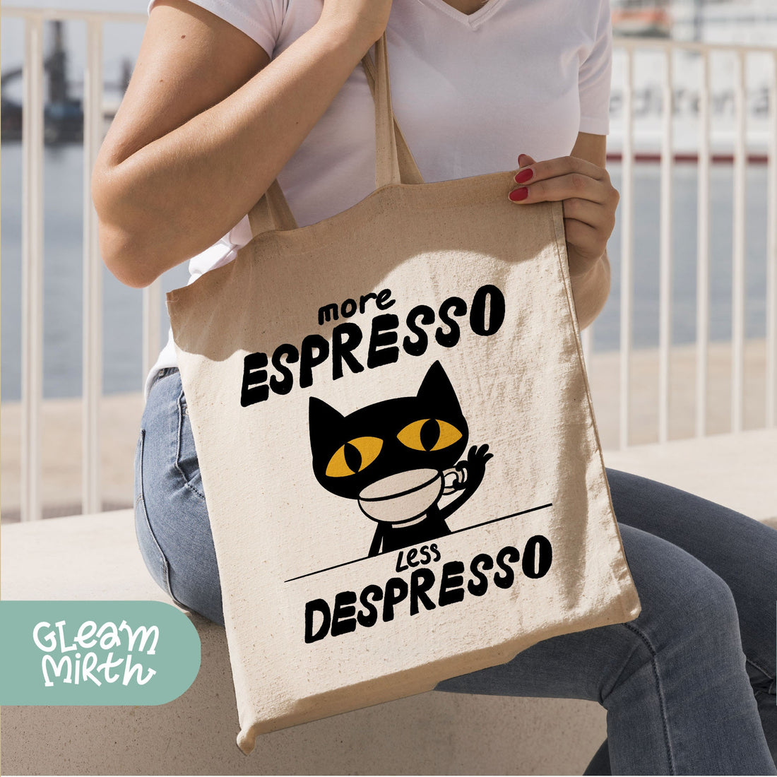 a person holding a white bag with a black cat on it