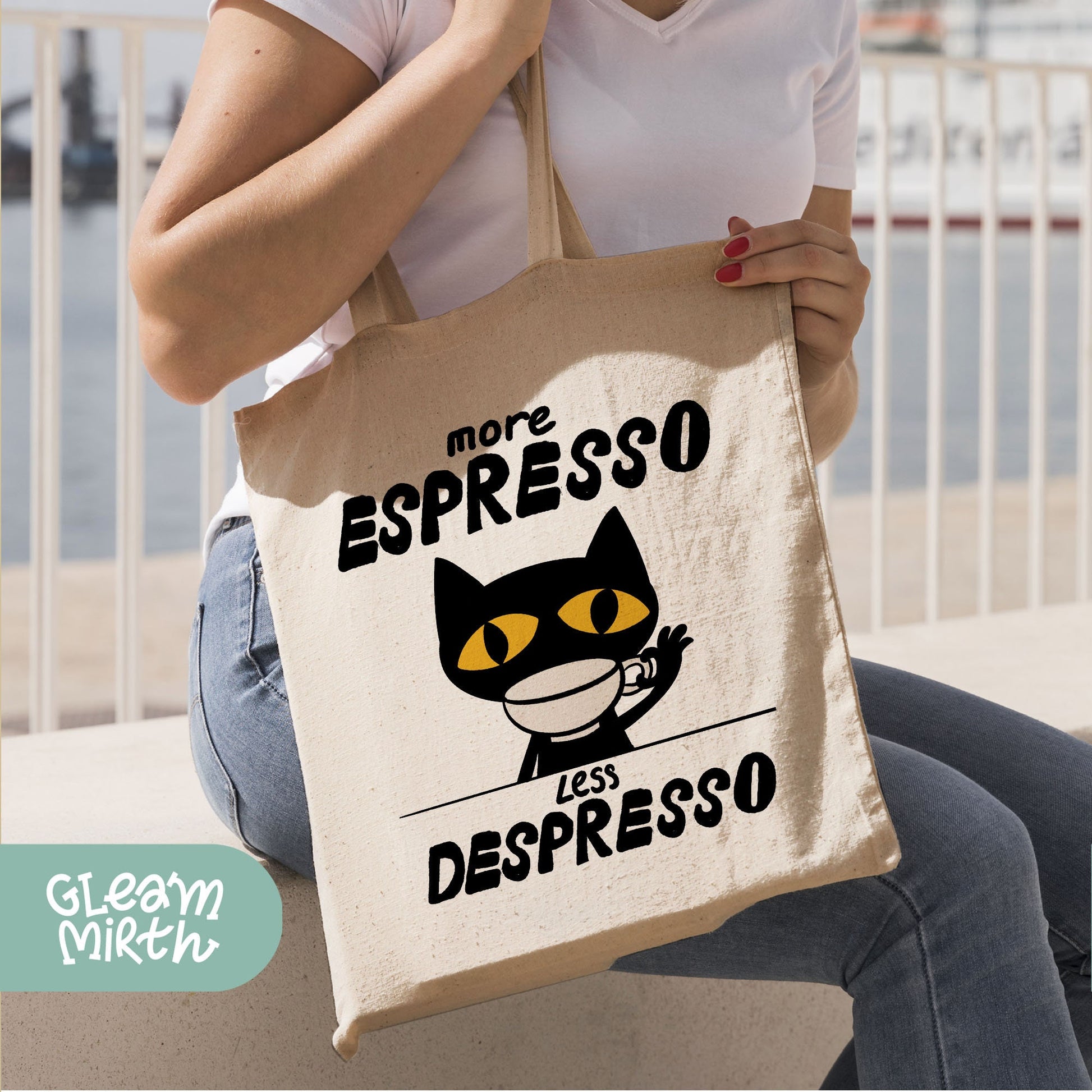 a woman holding a bag with a cat on it