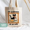 a tote bag with a picture of a cat and a bowl of food