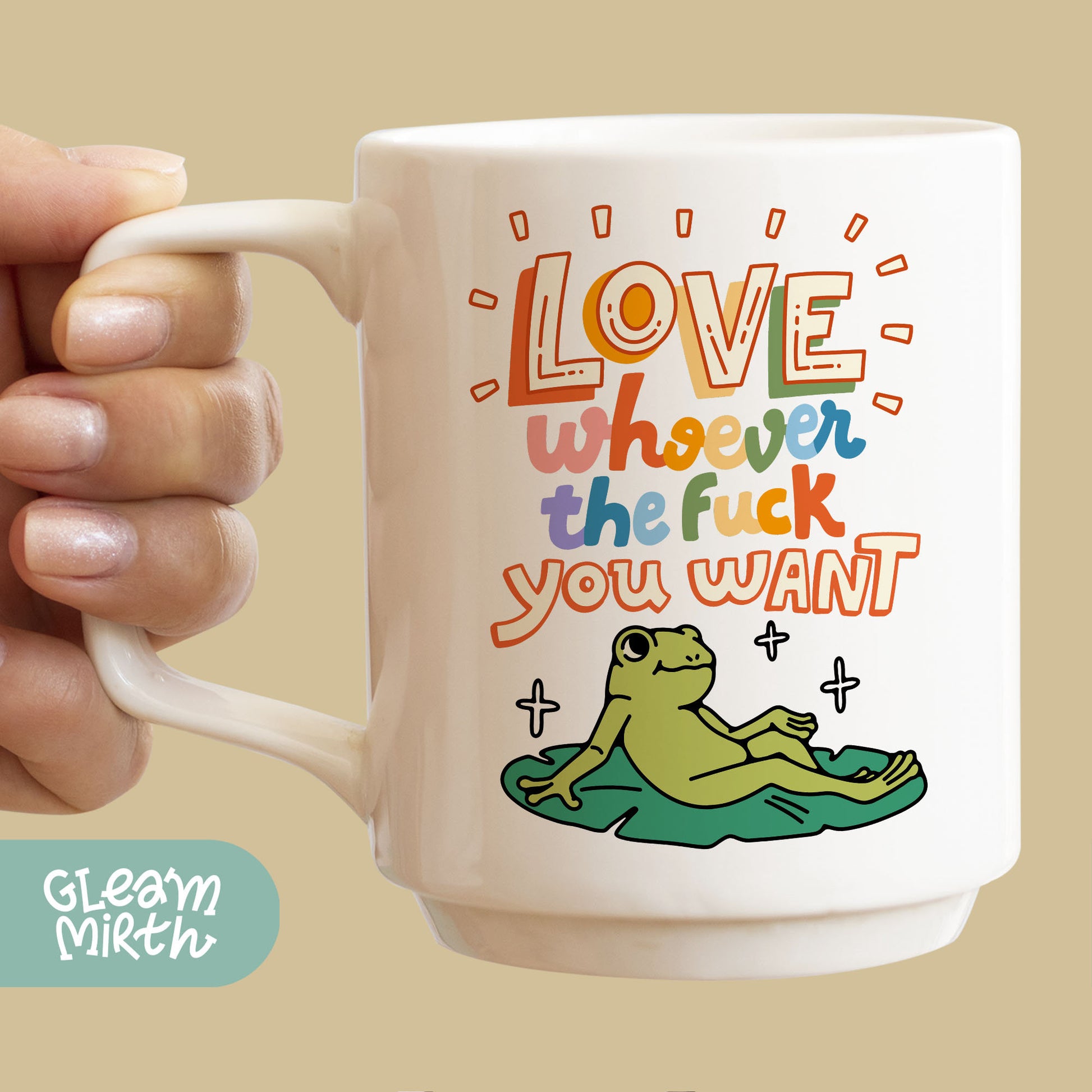 a person holding a coffee mug with a picture of a frog on it