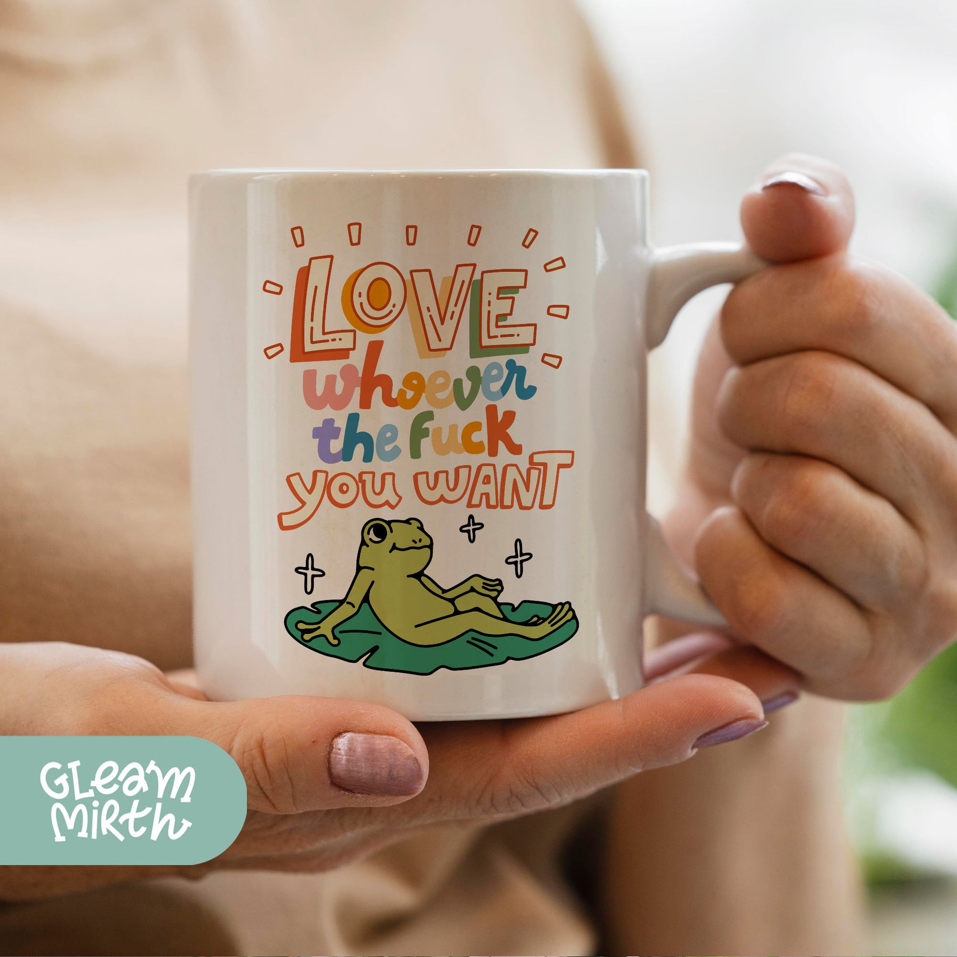 a woman holding a coffee mug with a frog on it