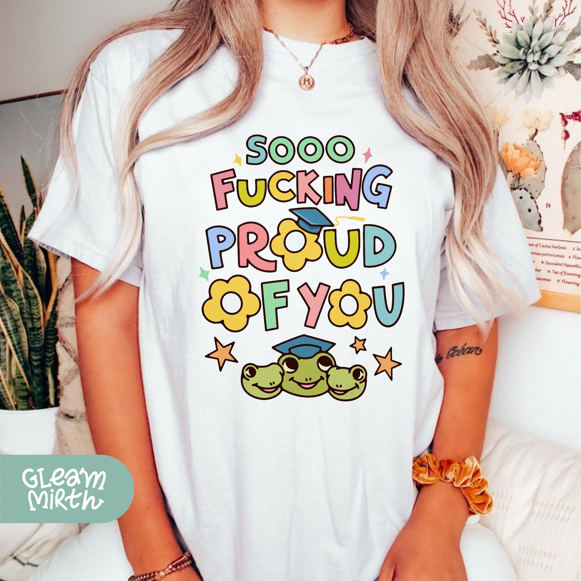 a woman wearing a t - shirt that says, goo fucking proud of you