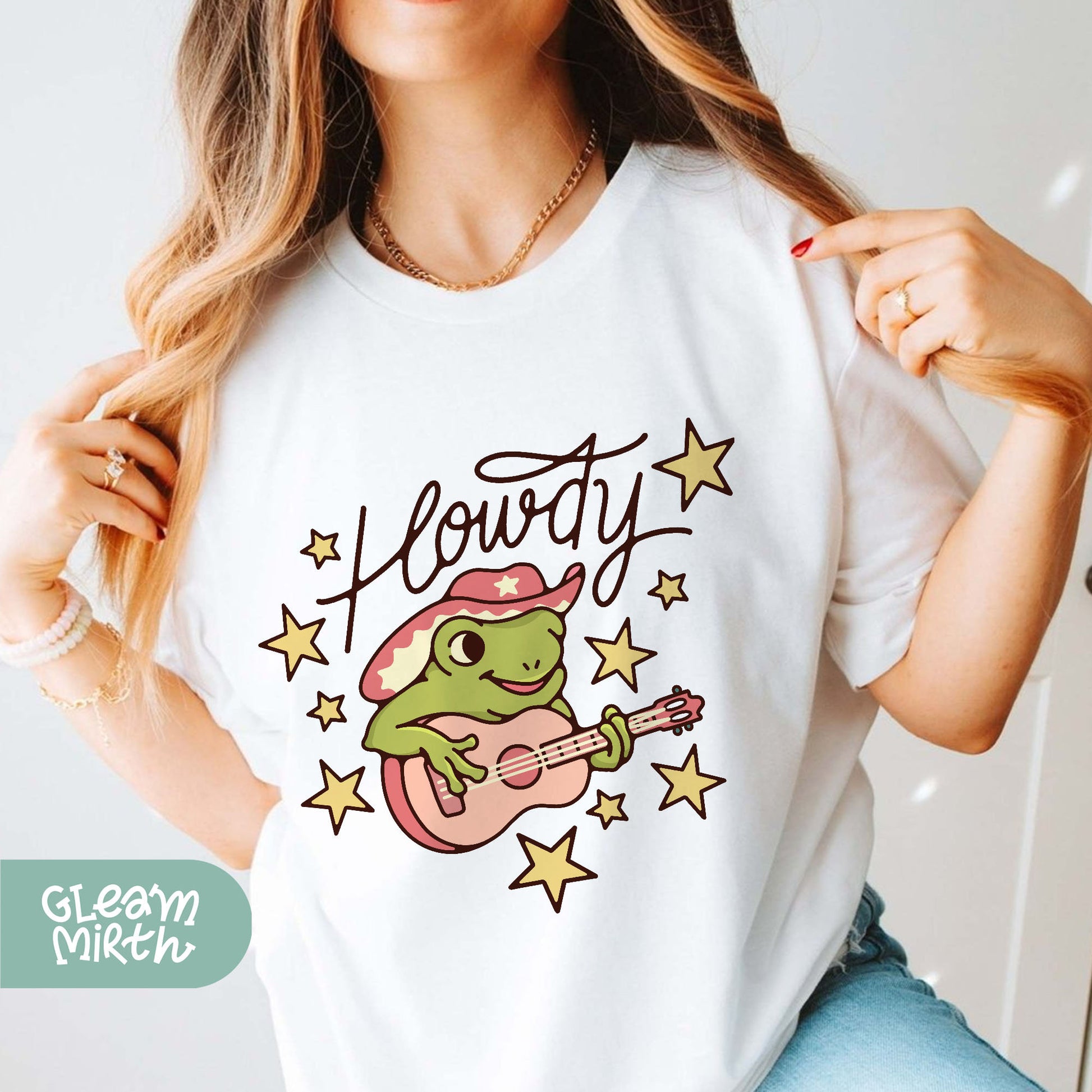 a woman wearing a white t - shirt with a frog on it