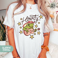 a woman wearing a t - shirt with a frog on it