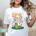 a woman wearing a white t - shirt with a frog on it