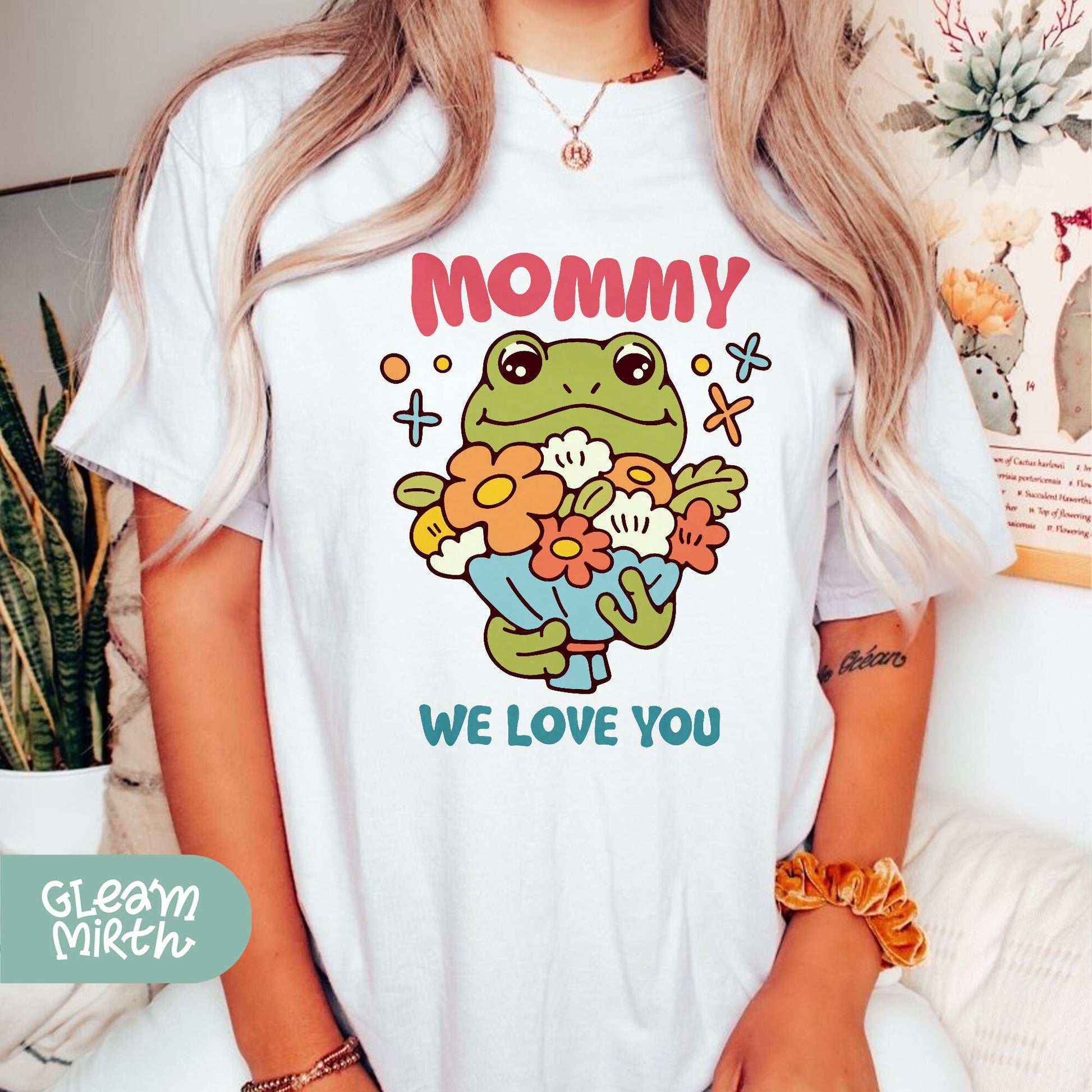 a woman wearing a t - shirt that says mommy we love you