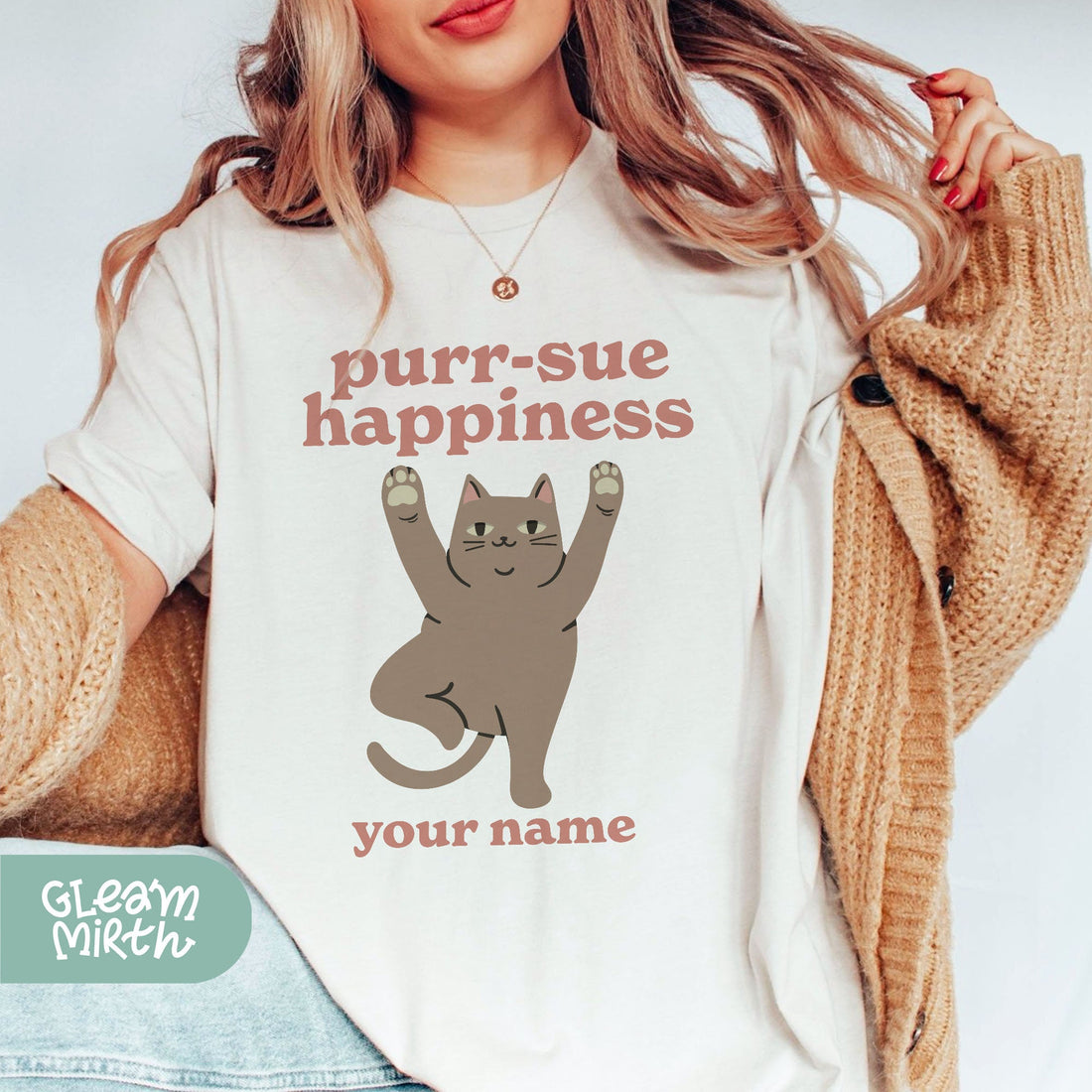 a woman wearing a t - shirt with a cat on it