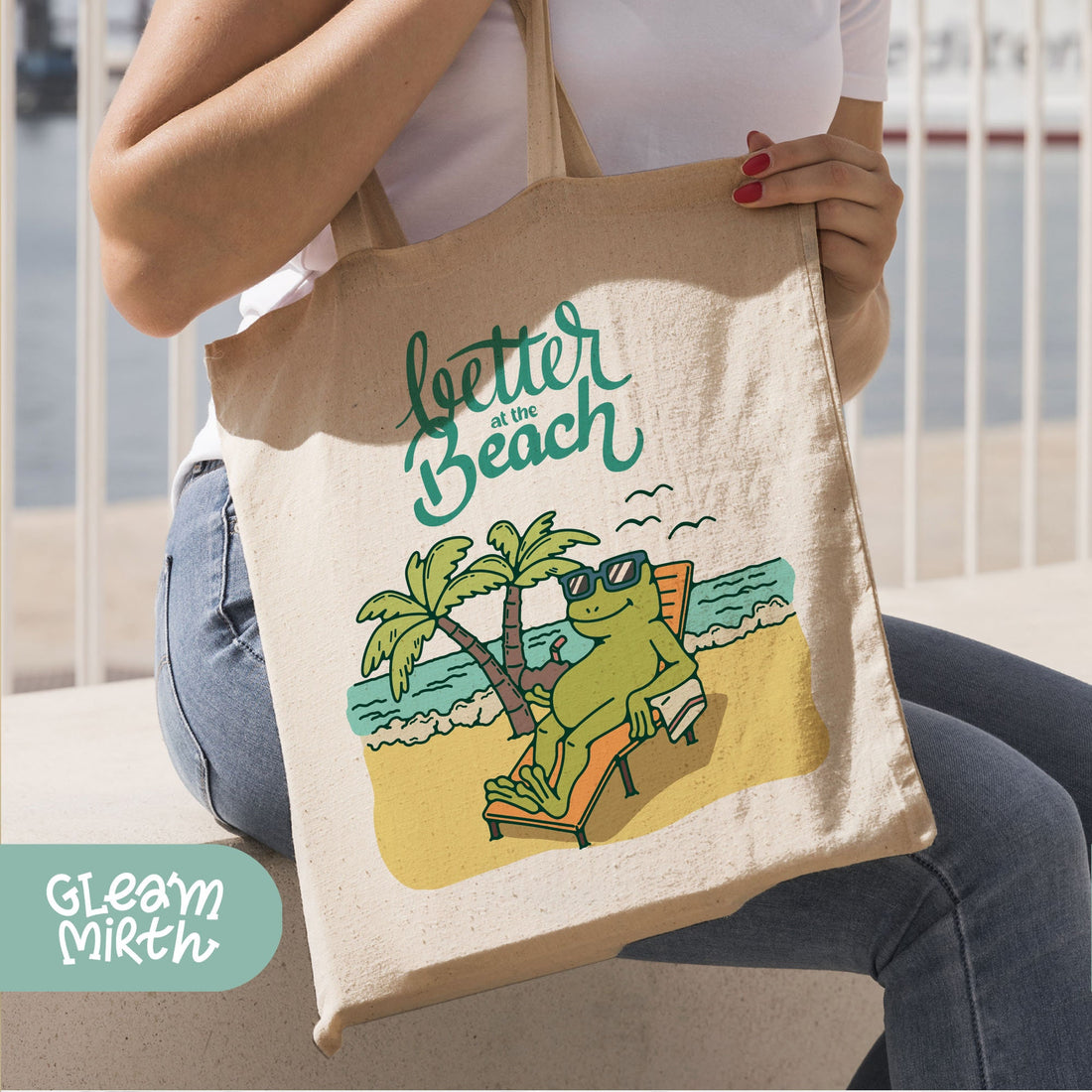 a tote bag with a picture of a frog on a beach