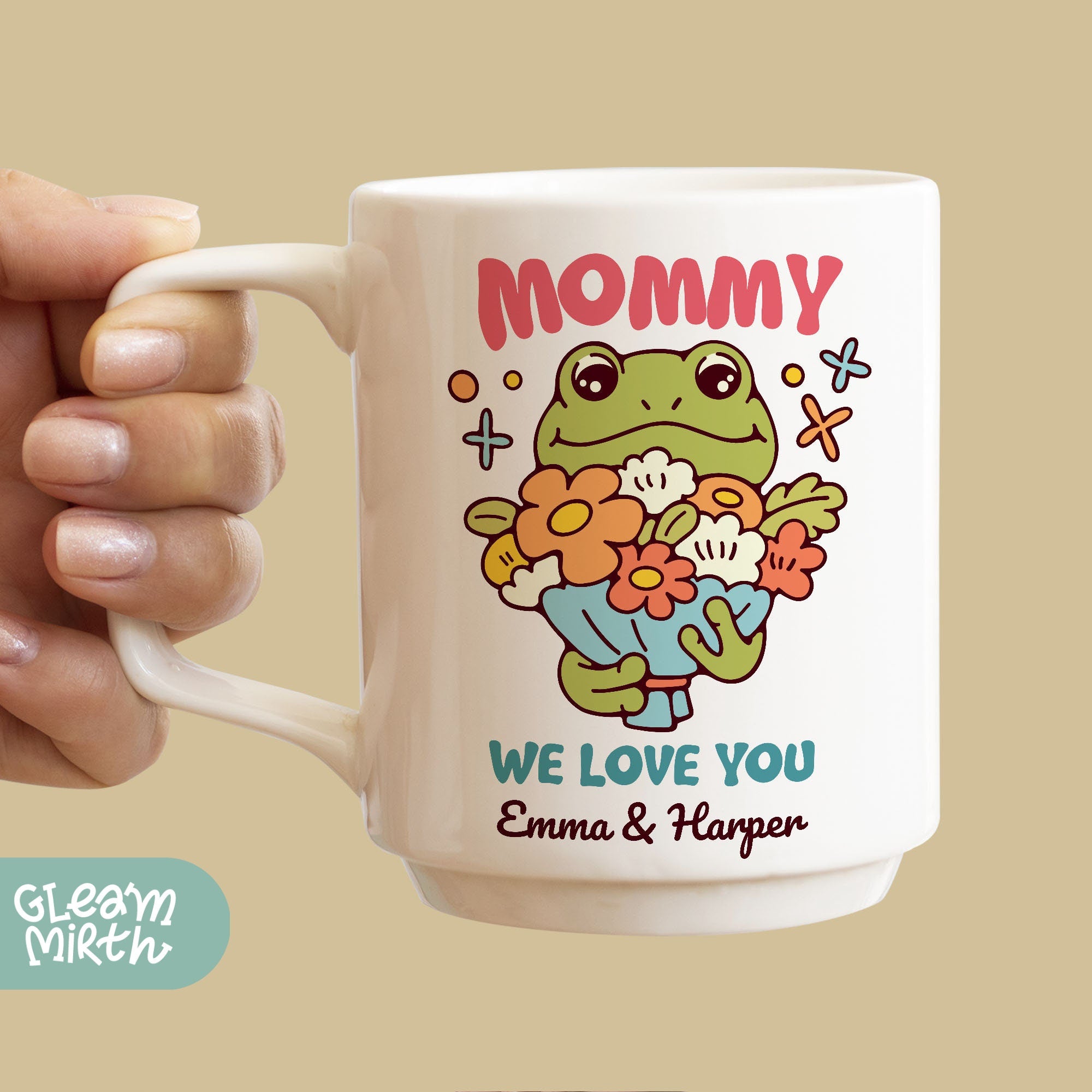 a person holding a coffee mug with a picture of a frog on it