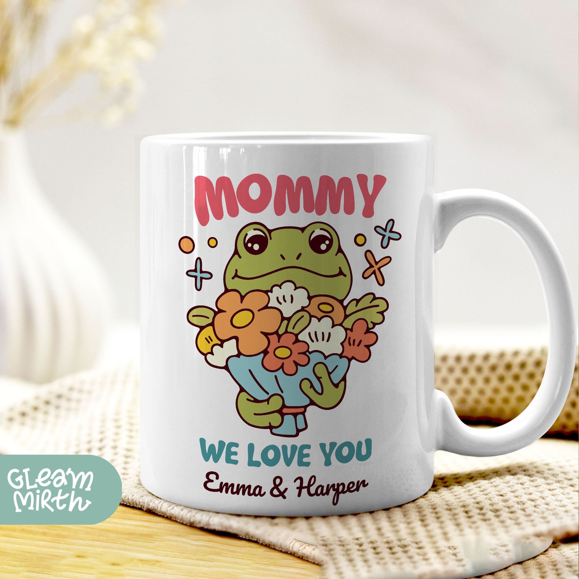 a coffee mug with a picture of a frog holding a flower