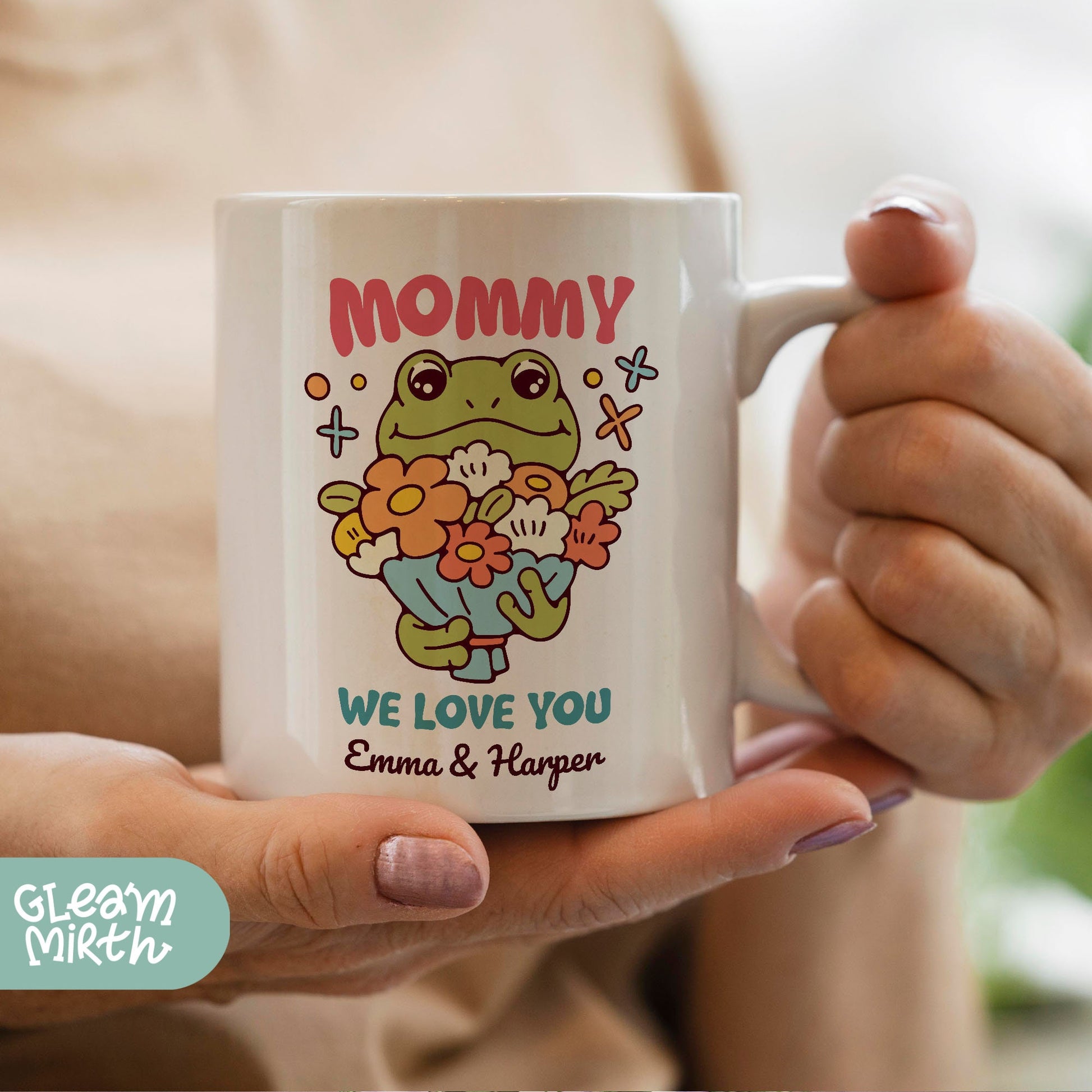 a woman holding a coffee mug with a frog on it