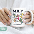 a person holding a coffee mug with a cartoon of people on it