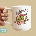 a person holding a coffee mug with a frog on it