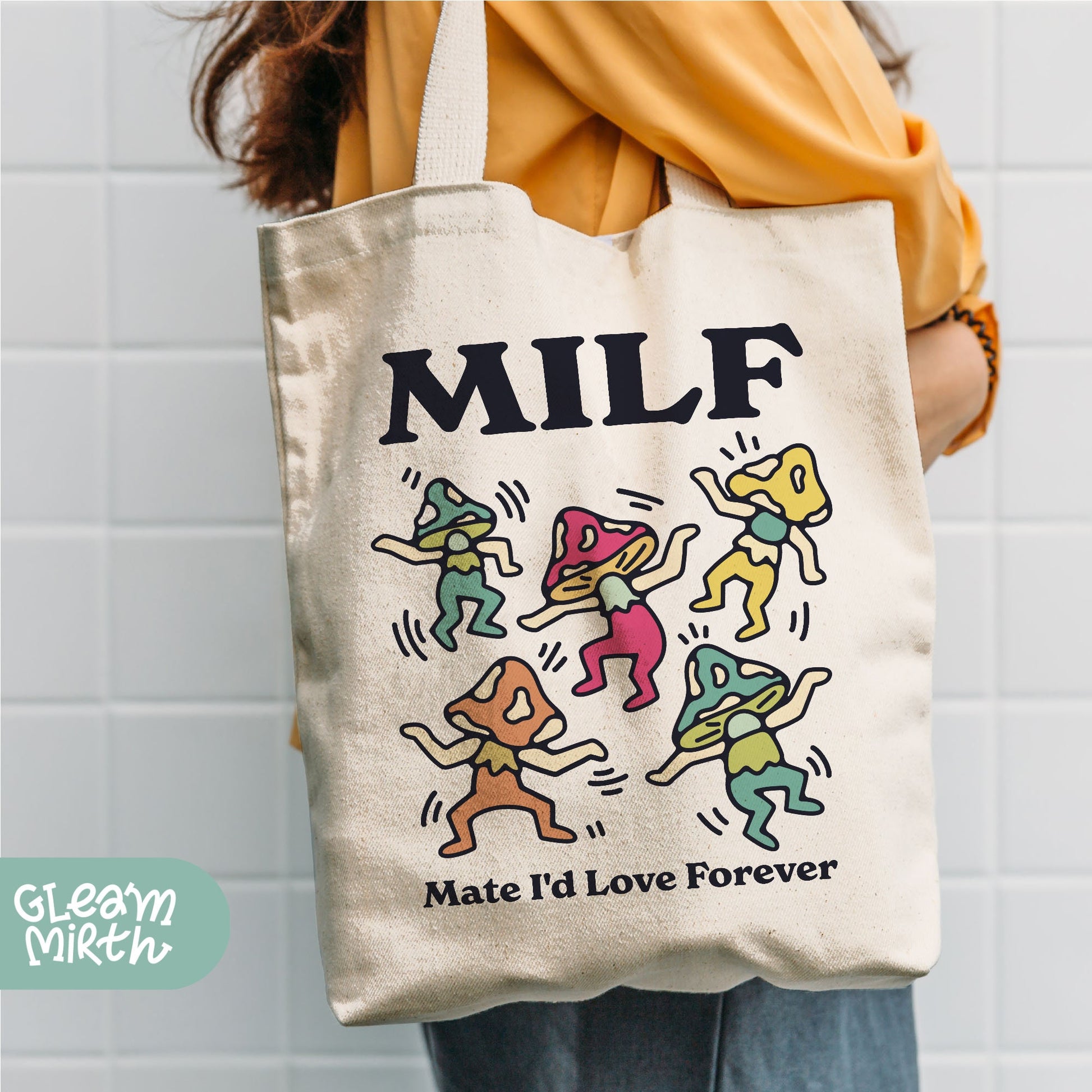 a person holding a tote bag that says milf