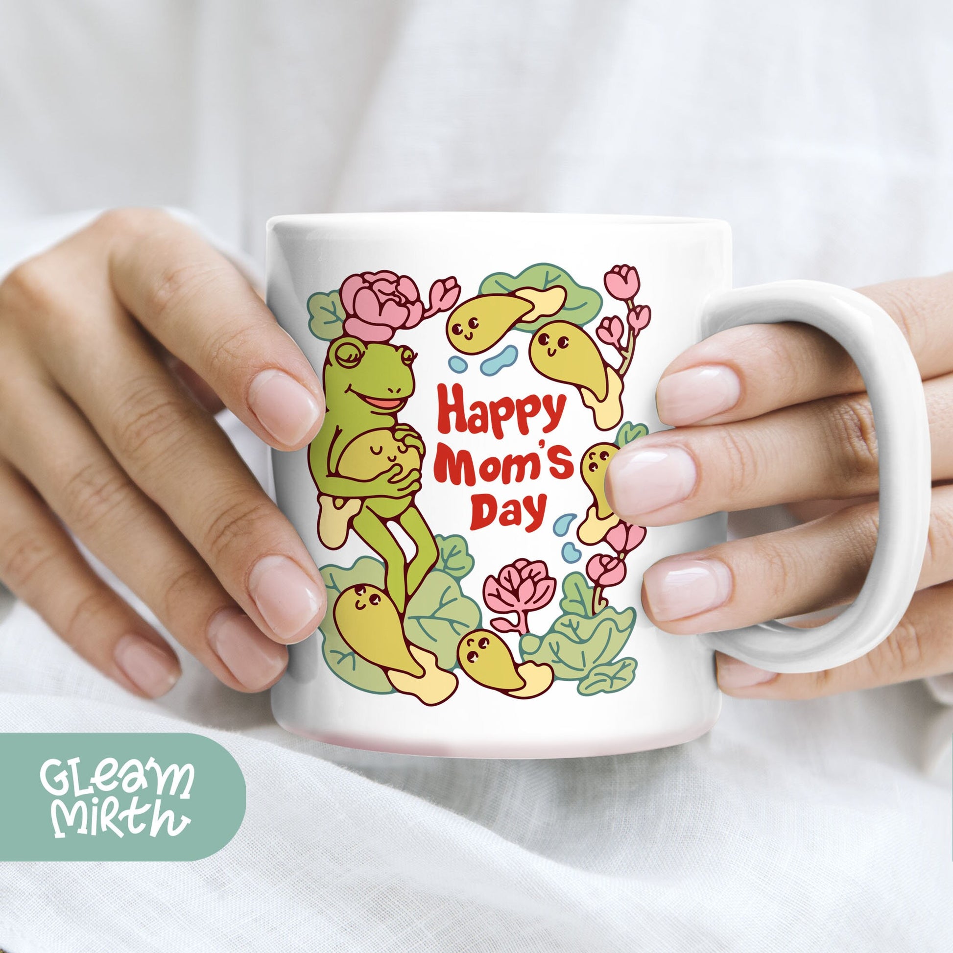 a woman holding a coffee mug with a happy mom&#39;s day design on it