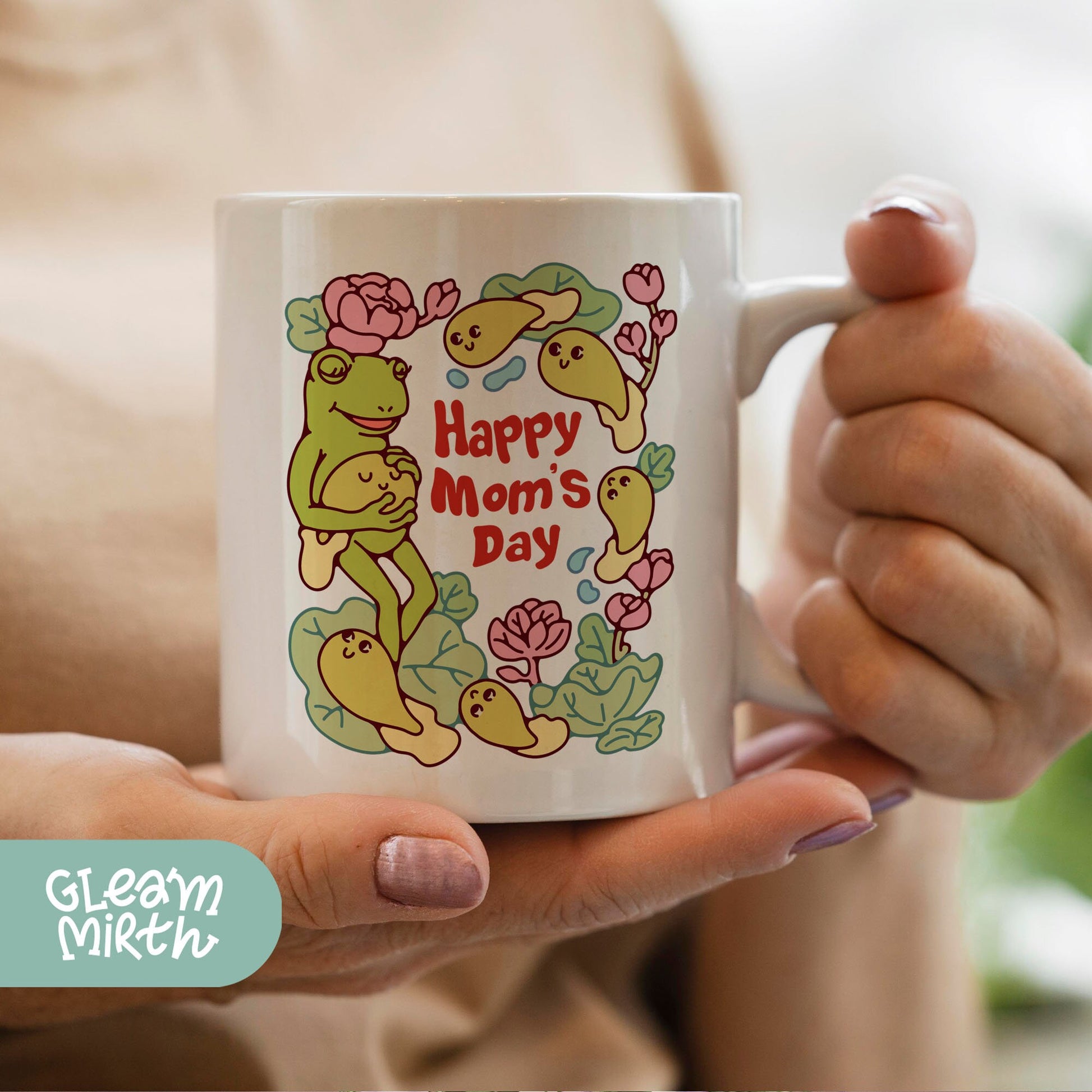 a woman holding a coffee mug with a happy mom&#39;s day design on it