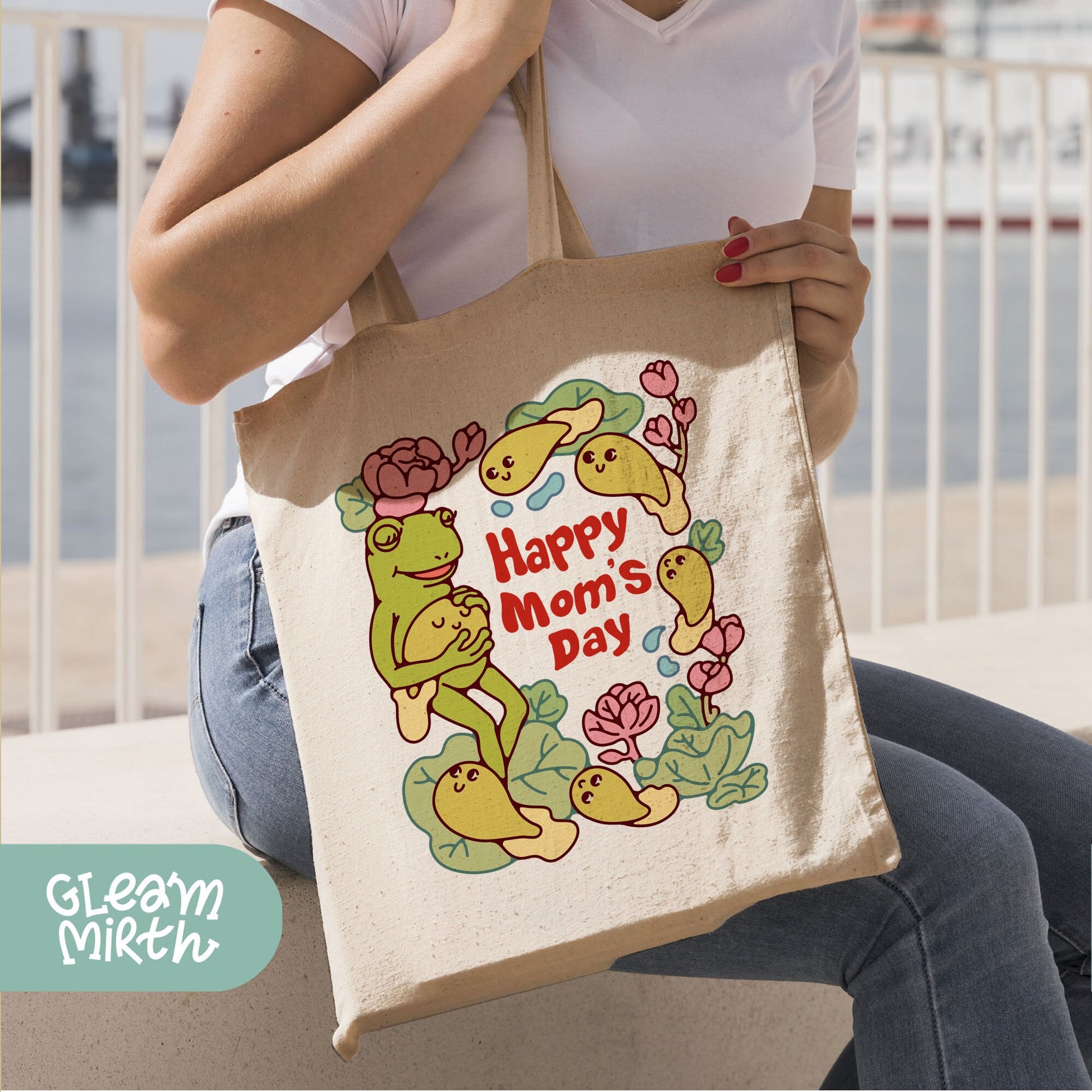 a woman sitting on a bench holding a happy mom&#39;s day bag