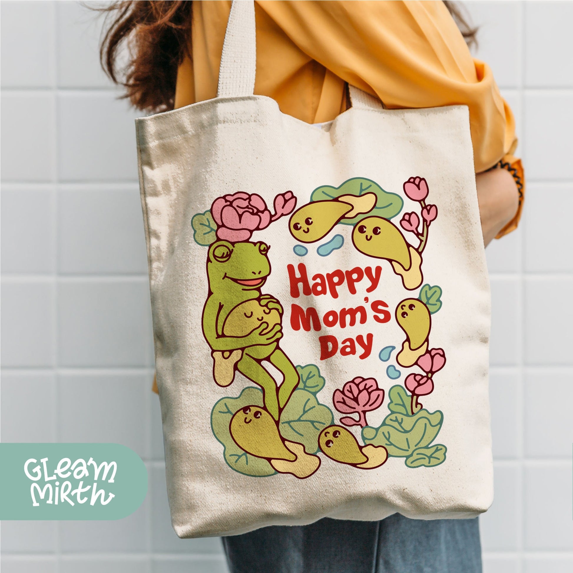 a woman holding a happy mom&#39;s day tote bag