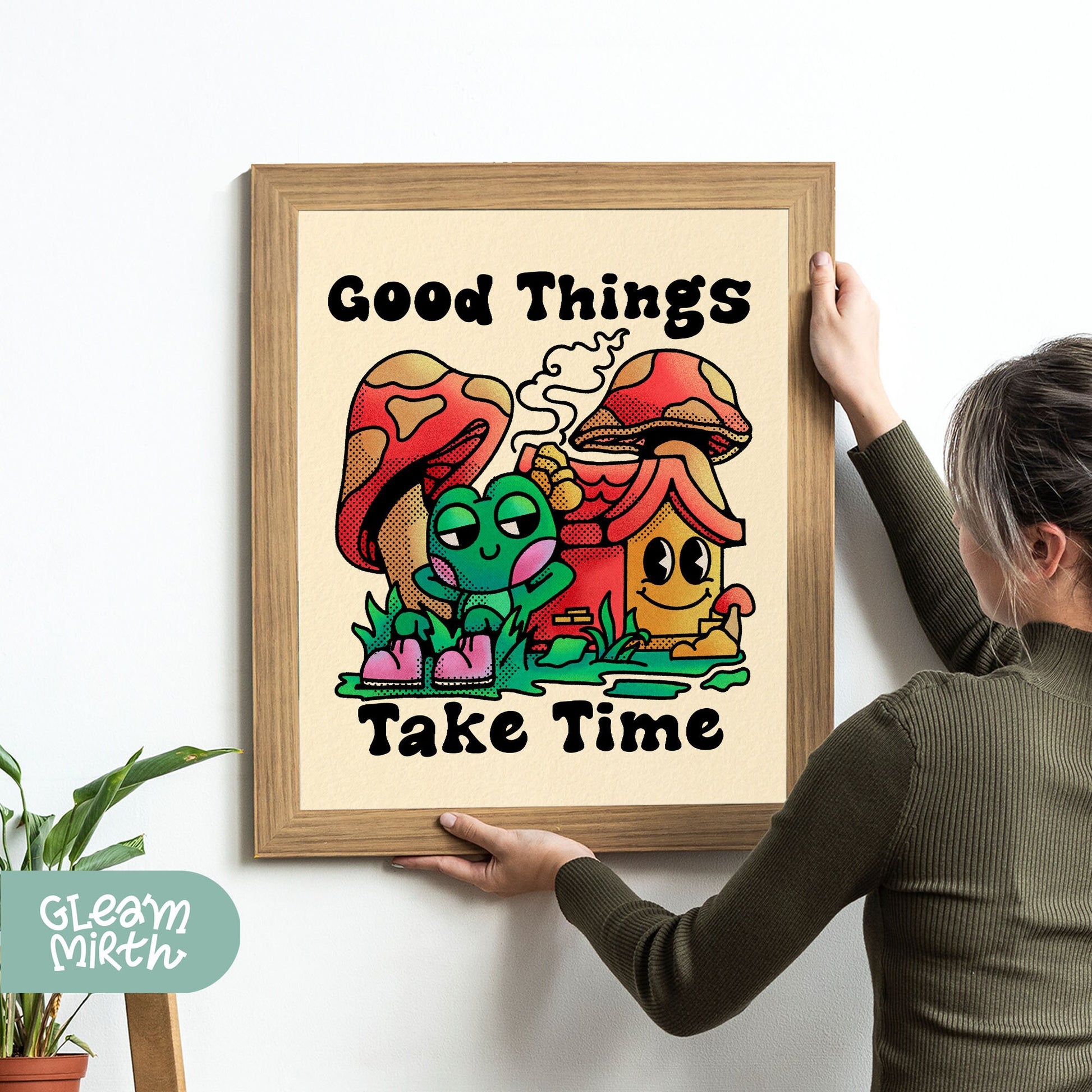 a woman holding up a picture of a mushroom house