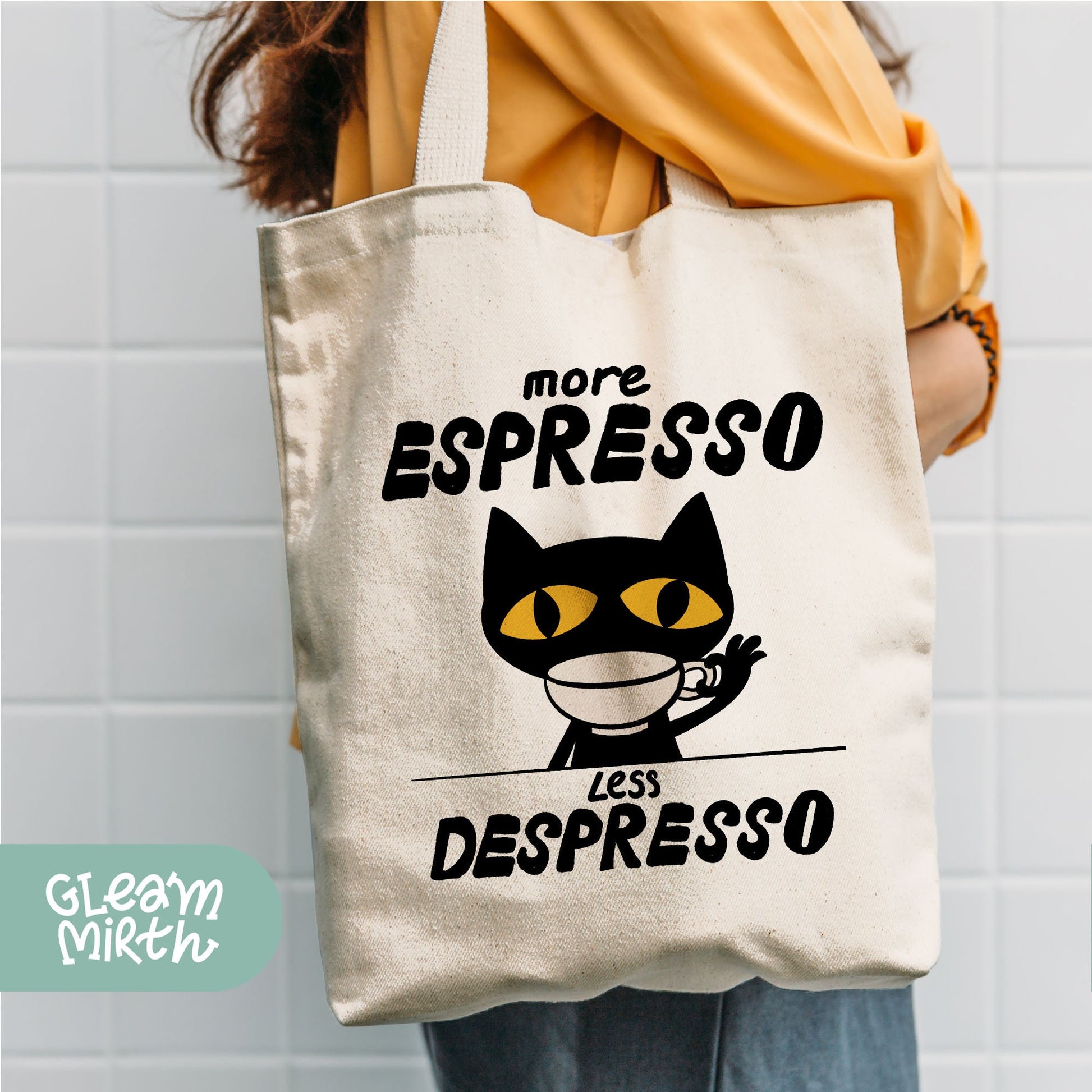 a person holding a white bag with a black cat on it