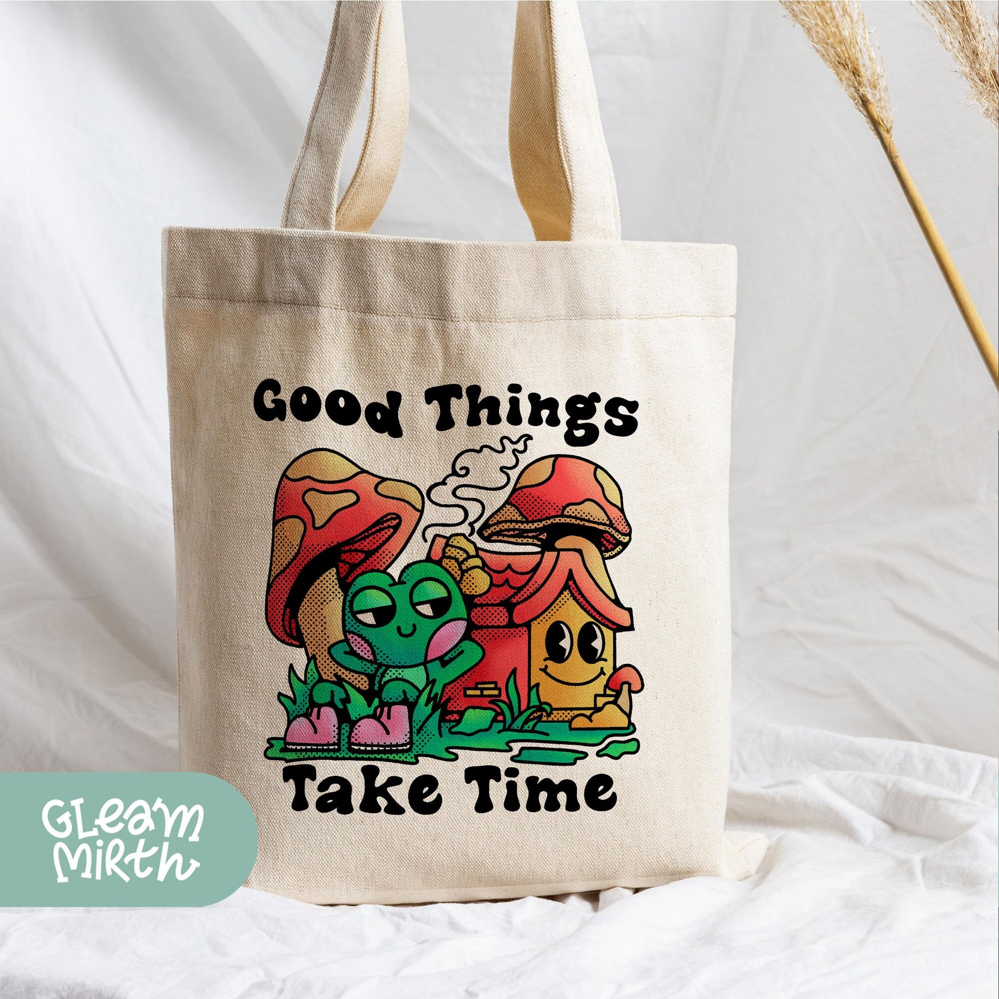 a tote bag with an image of a mushroom and a mushroom house