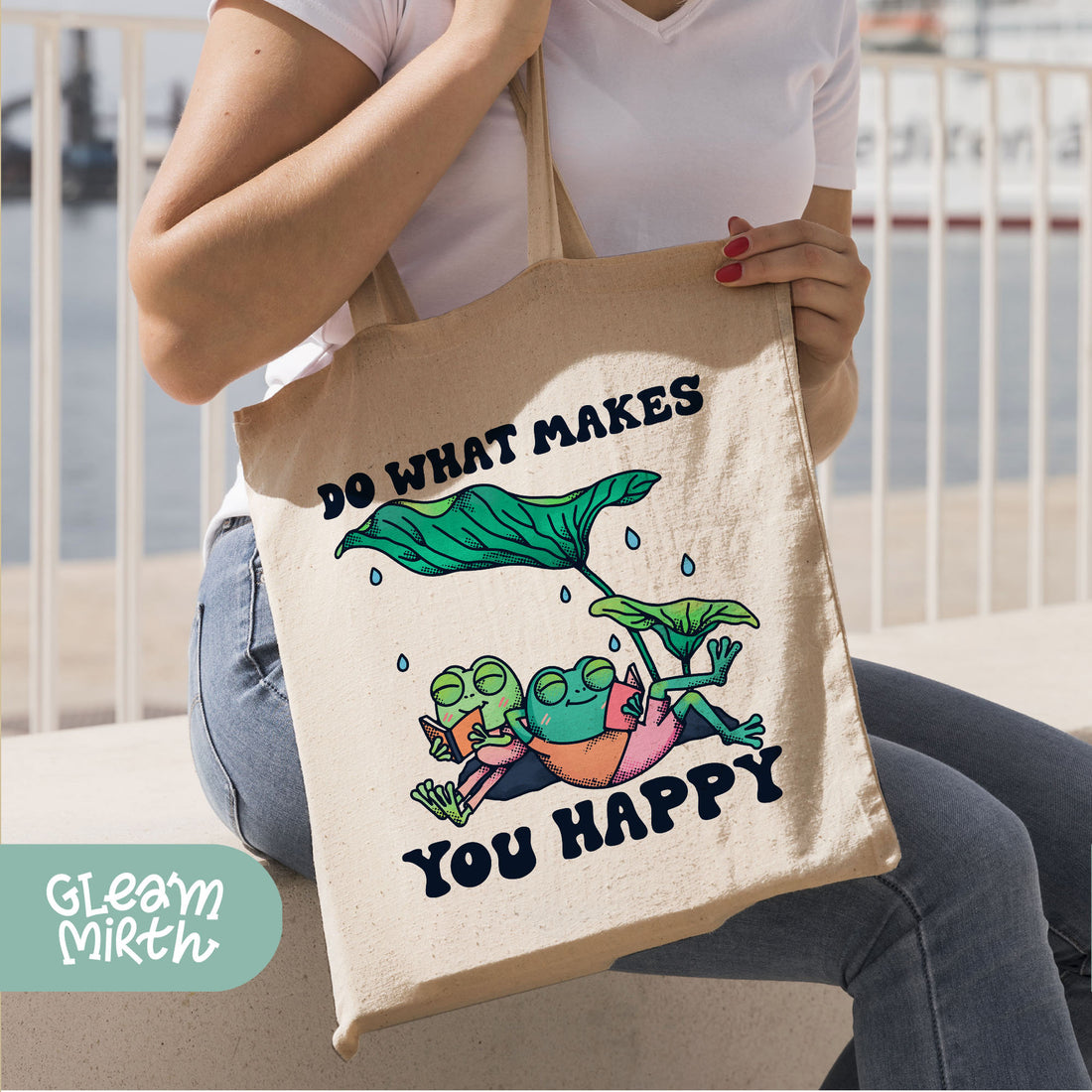 a hand holding a tote bag that says do what makes you happy