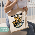 a woman holding a tea time bag with a cat on it