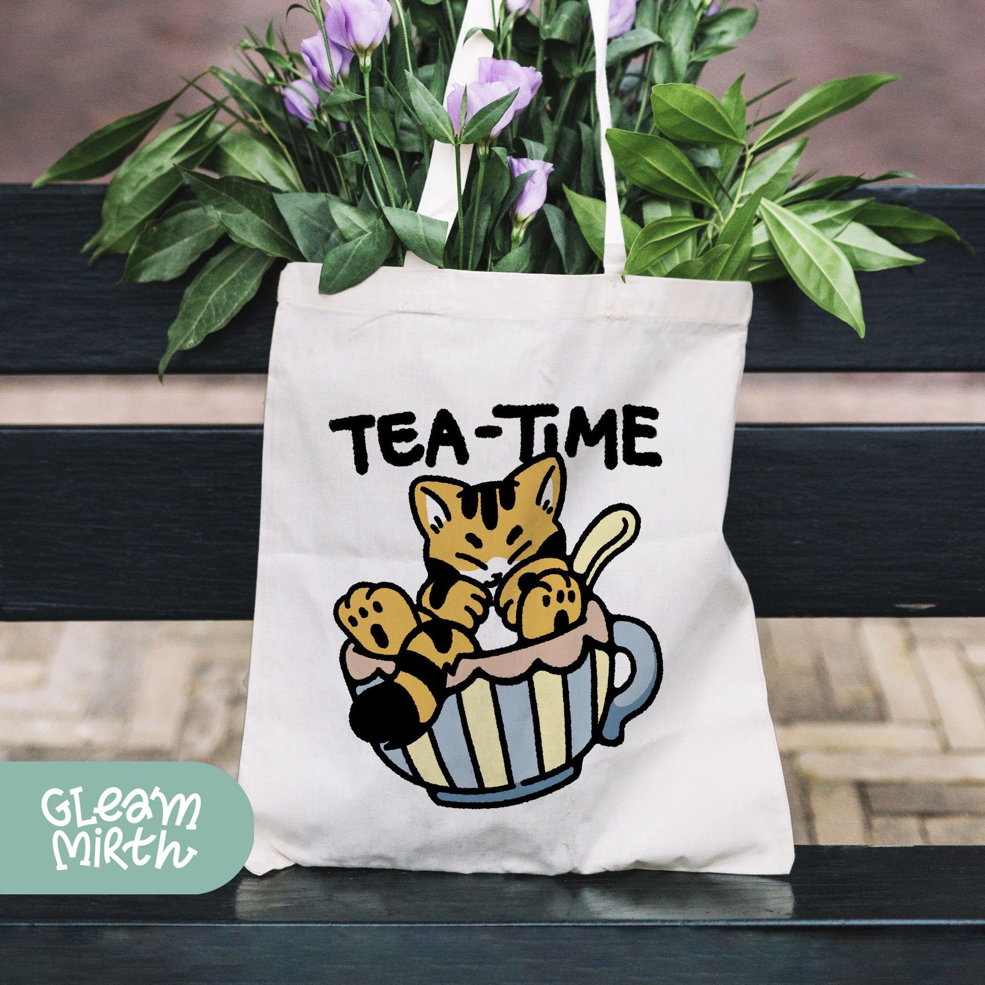 a tea - time tote bag sitting on a bench