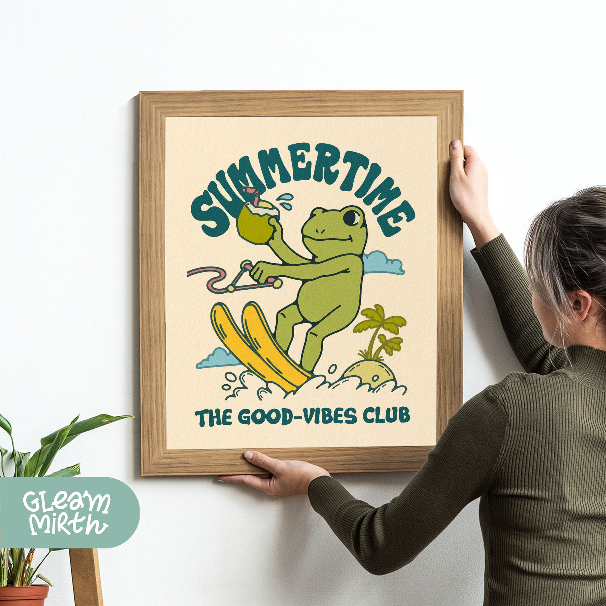 a woman holding up a picture of a frog on a surfboard