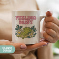 a woman holding a coffee mug with a frog on it