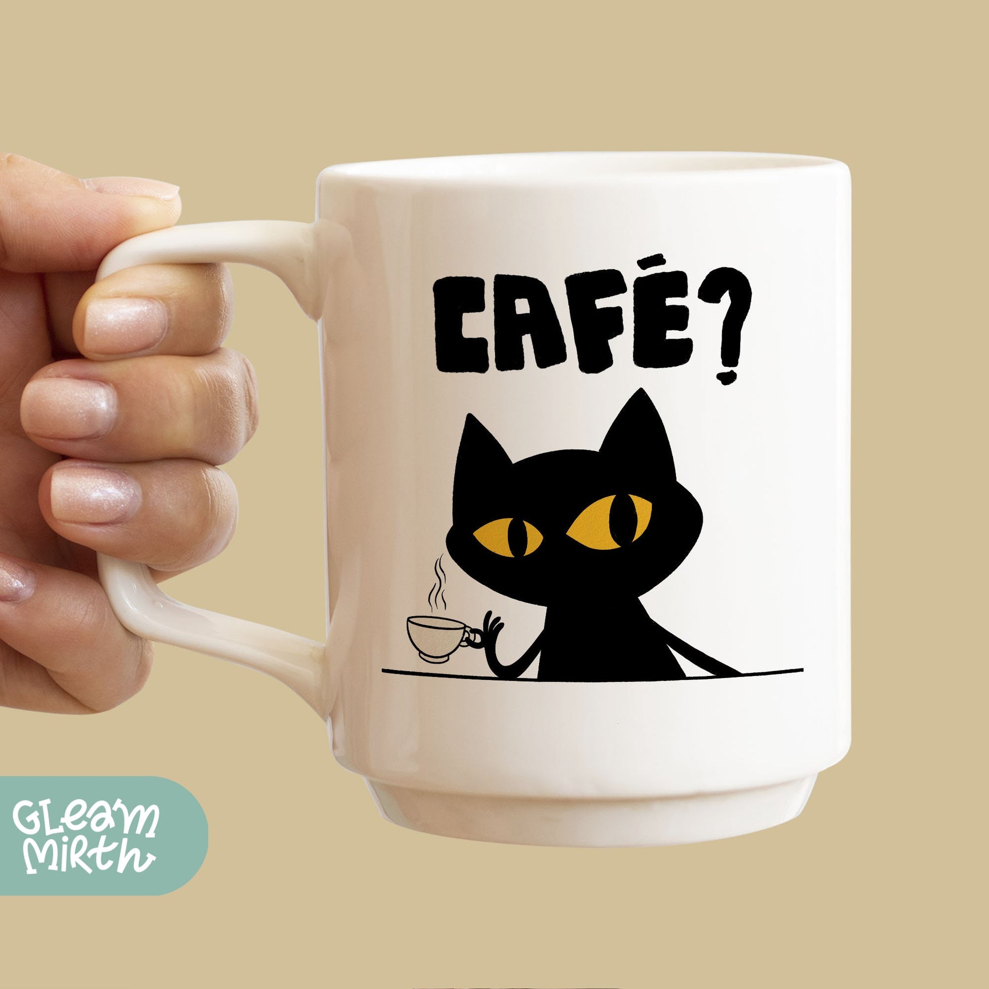 a person holding a coffee mug with a cat on it