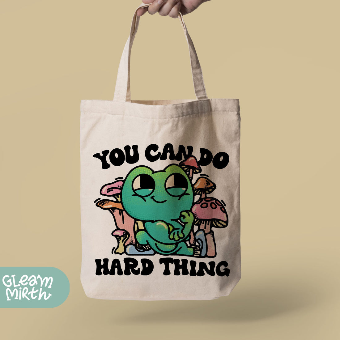 a woman holding a bag that says you can do hard thing