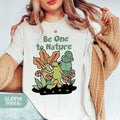 a woman wearing a t - shirt that says be one to nature