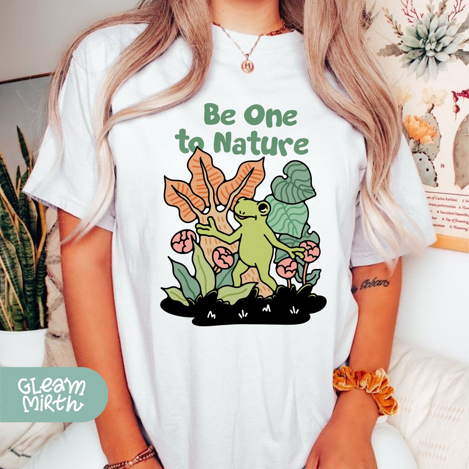 a woman wearing a t - shirt that says be one to nature