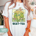 a woman wearing a t - shirt that says best - tea