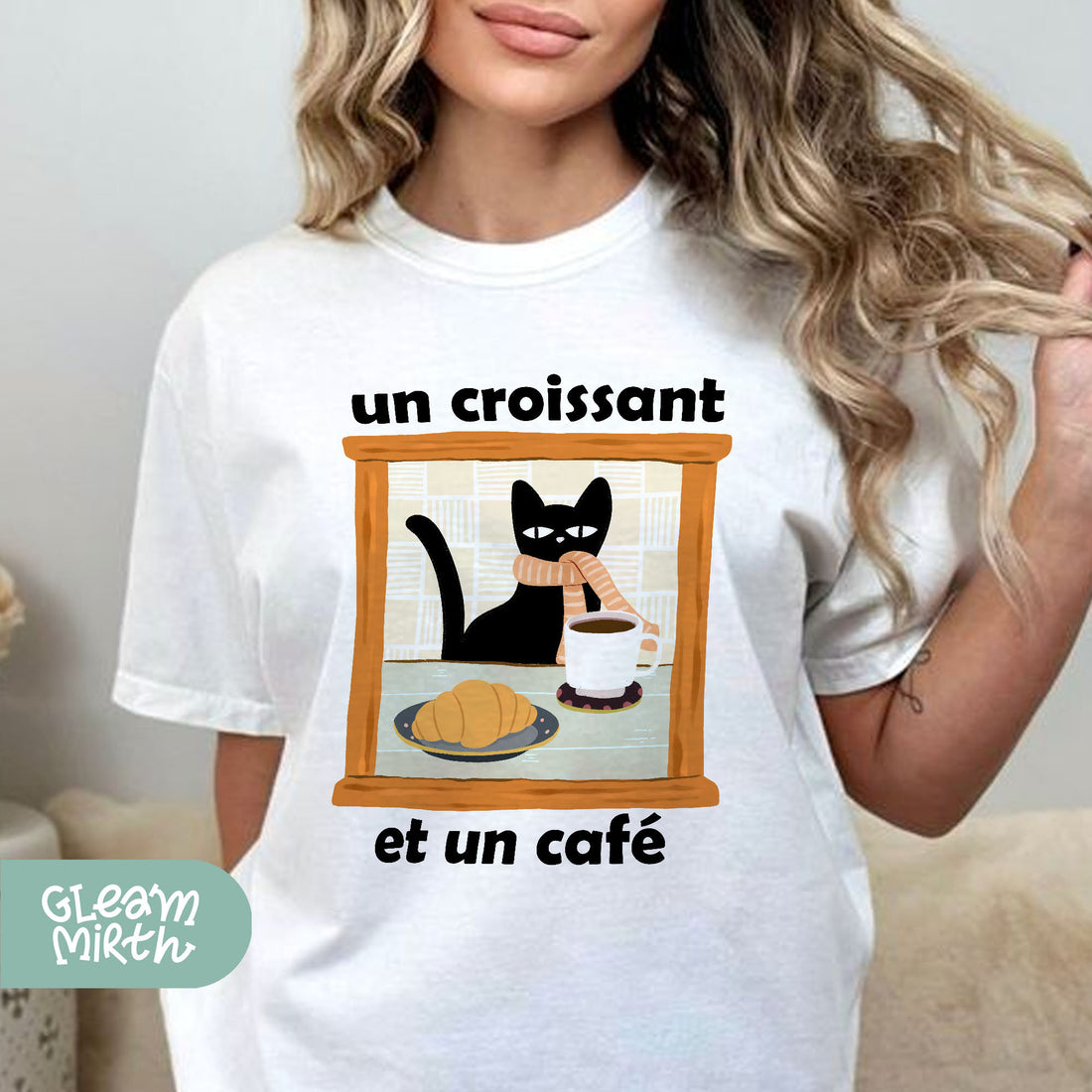 a woman wearing a white shirt with a black cat on it