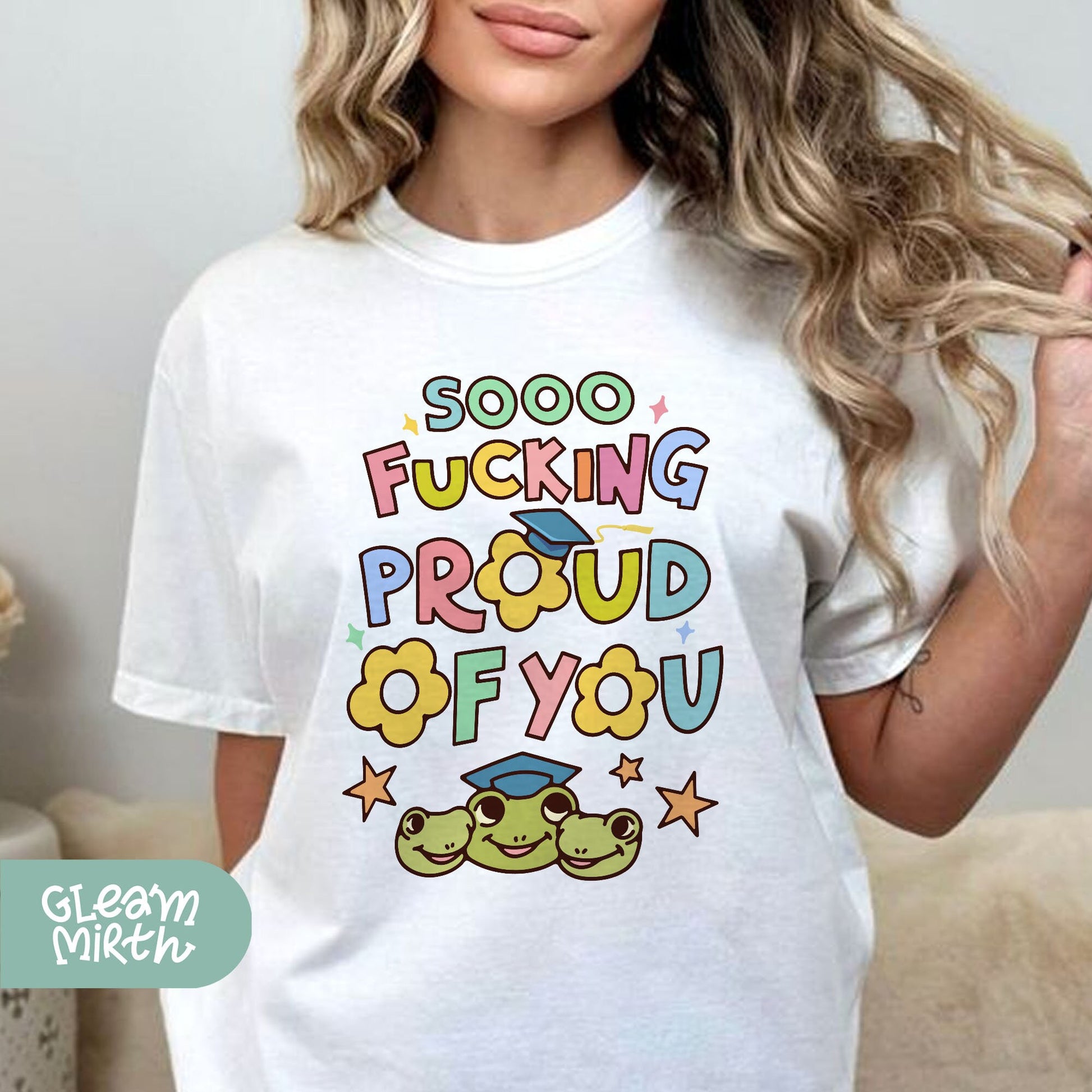 a woman wearing a white t - shirt that says, soo fucking proud of you