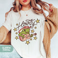 a woman wearing a t - shirt with a frog on it