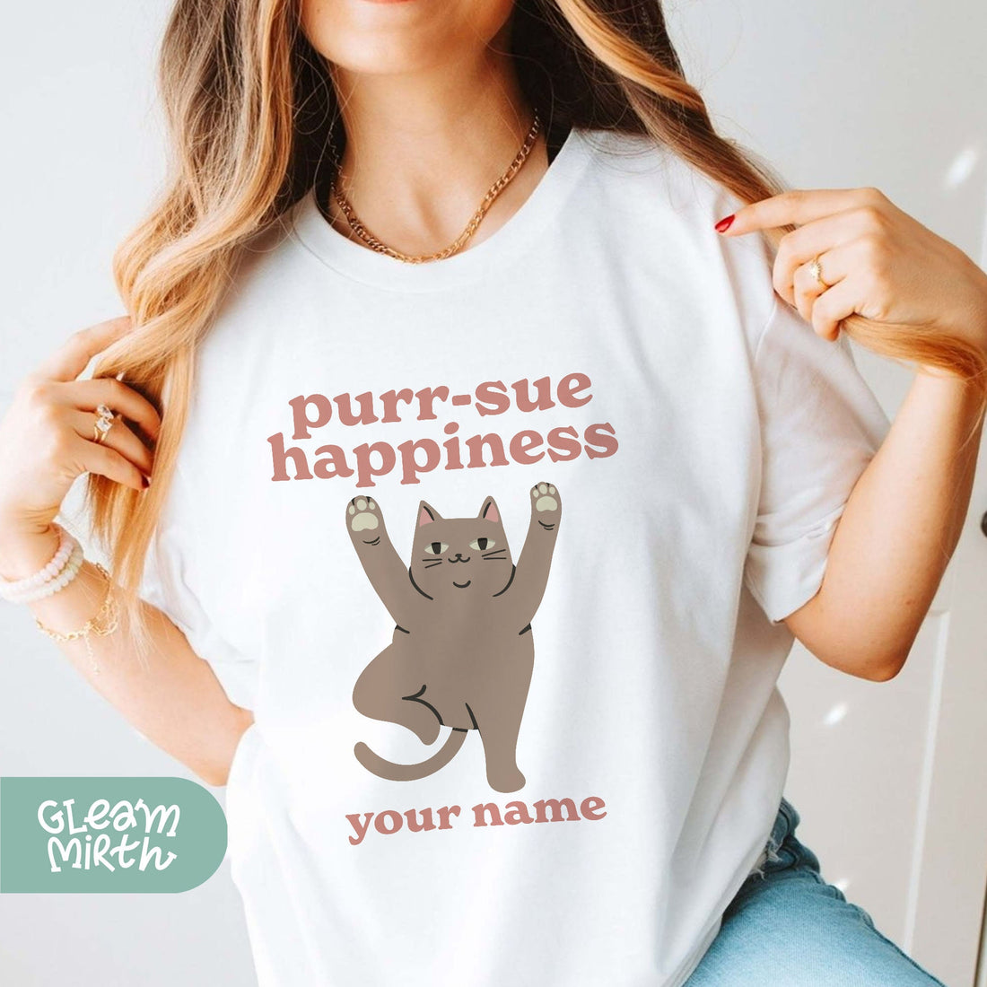 a woman wearing a t - shirt with a cat on it