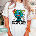 a woman wearing a t - shirt that says support your local planet