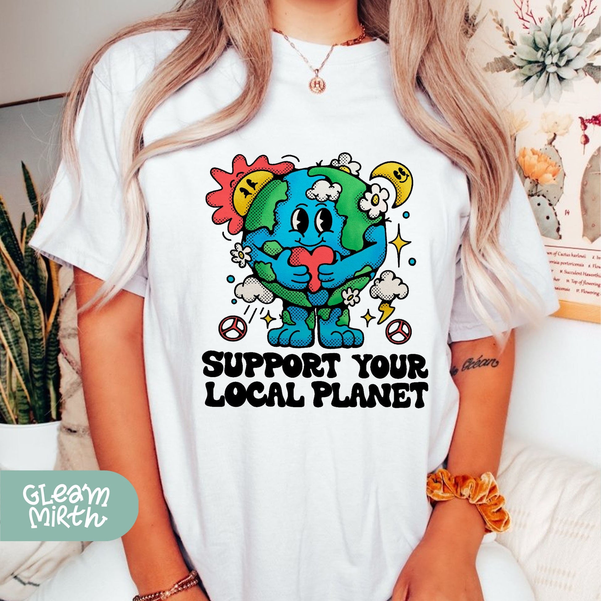 a woman wearing a t - shirt that says support your local planet