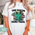 a woman wearing a t - shirt that says you can't do hard thing