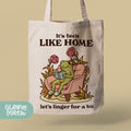 a tote bag with a frog sitting on a chair