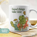 a coffee mug with a frog sitting on a flower